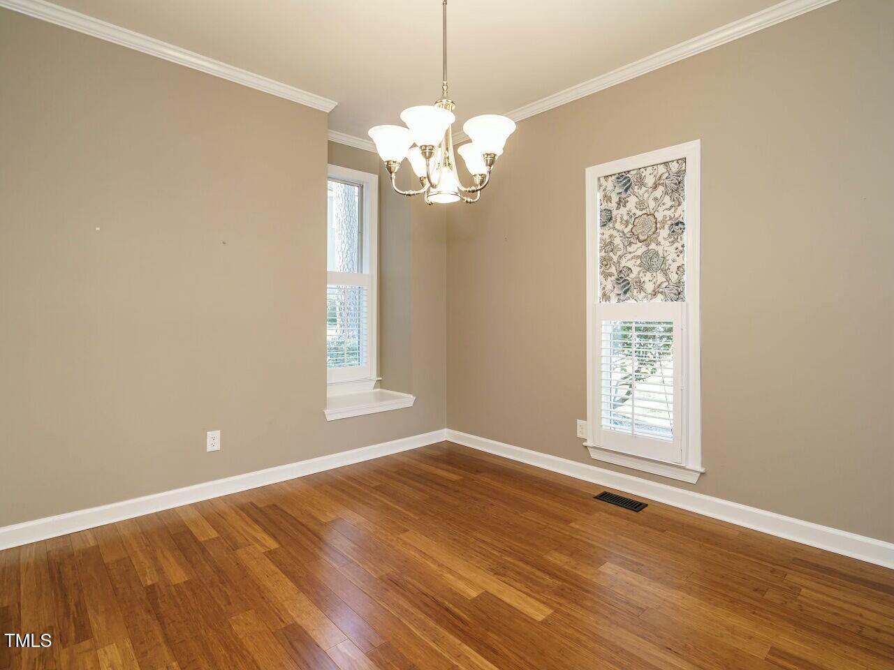 5917 Sentinel Drive Raleigh, NC 27609 - Photo 12 of 32 an empty room with wooden floor and windows