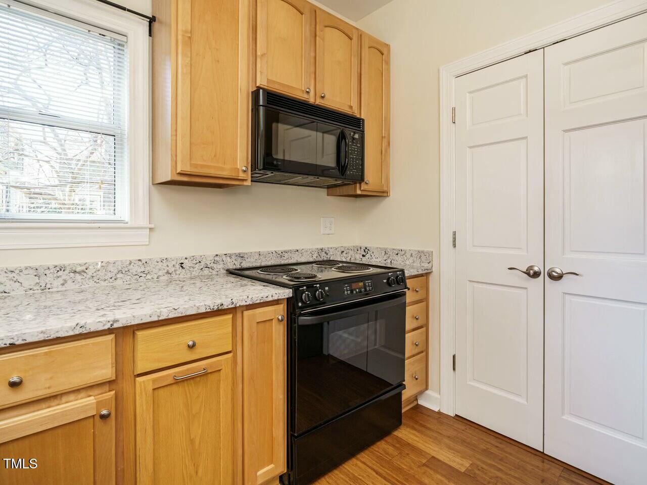 5917 Sentinel Drive Raleigh, NC 27609 - Photo 16 of 32 a kitchen with granite countertop cabinets stainless steel appliances and wooden floor
