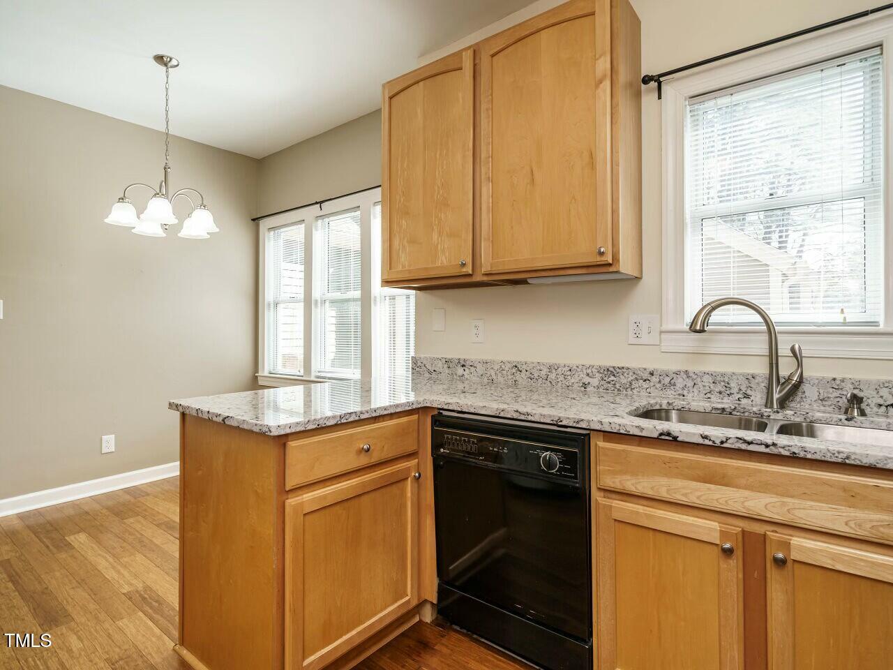 5917 Sentinel Drive Raleigh, NC 27609 - Photo 18 of 32 a kitchen with stainless steel appliances granite countertop a sink a stove and a microwave