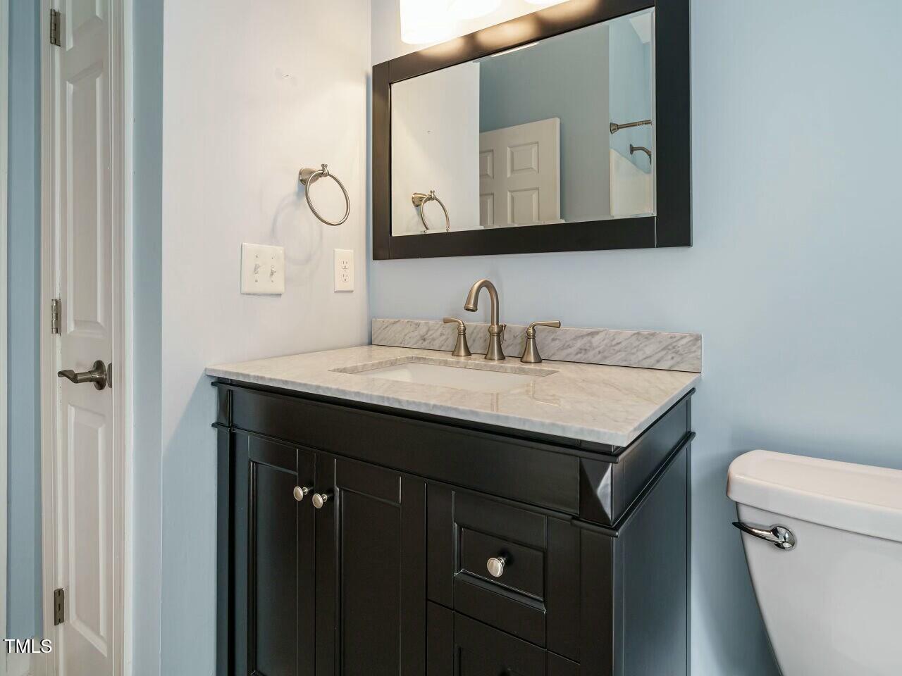 5917 Sentinel Drive Raleigh, NC 27609 - Photo 25 of 32 a bathroom with a sink vanity and a toilet