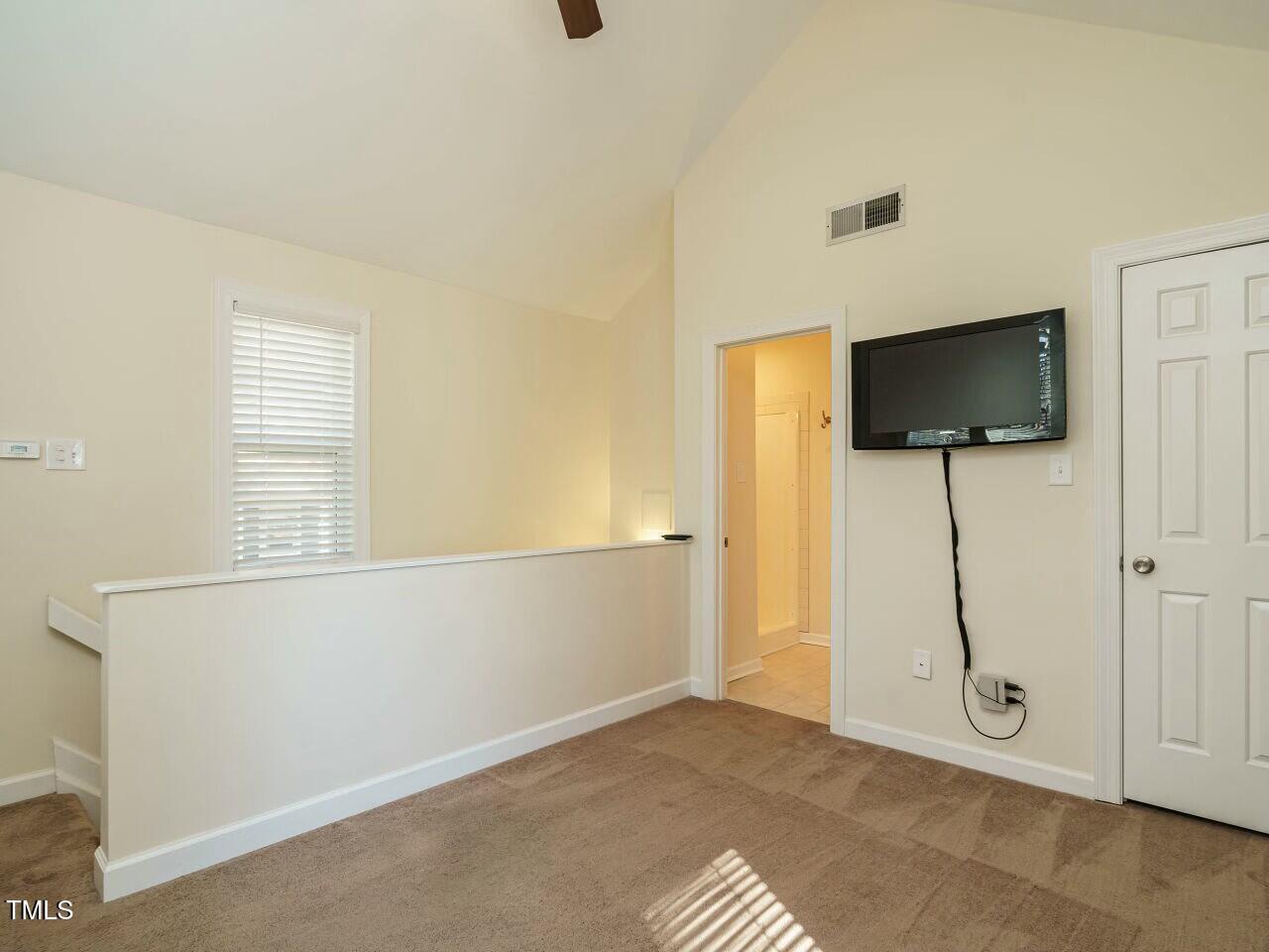 5917 Sentinel Drive Raleigh, NC 27609 - Photo 29 of 32 a view of an empty room with wooden floor and a window