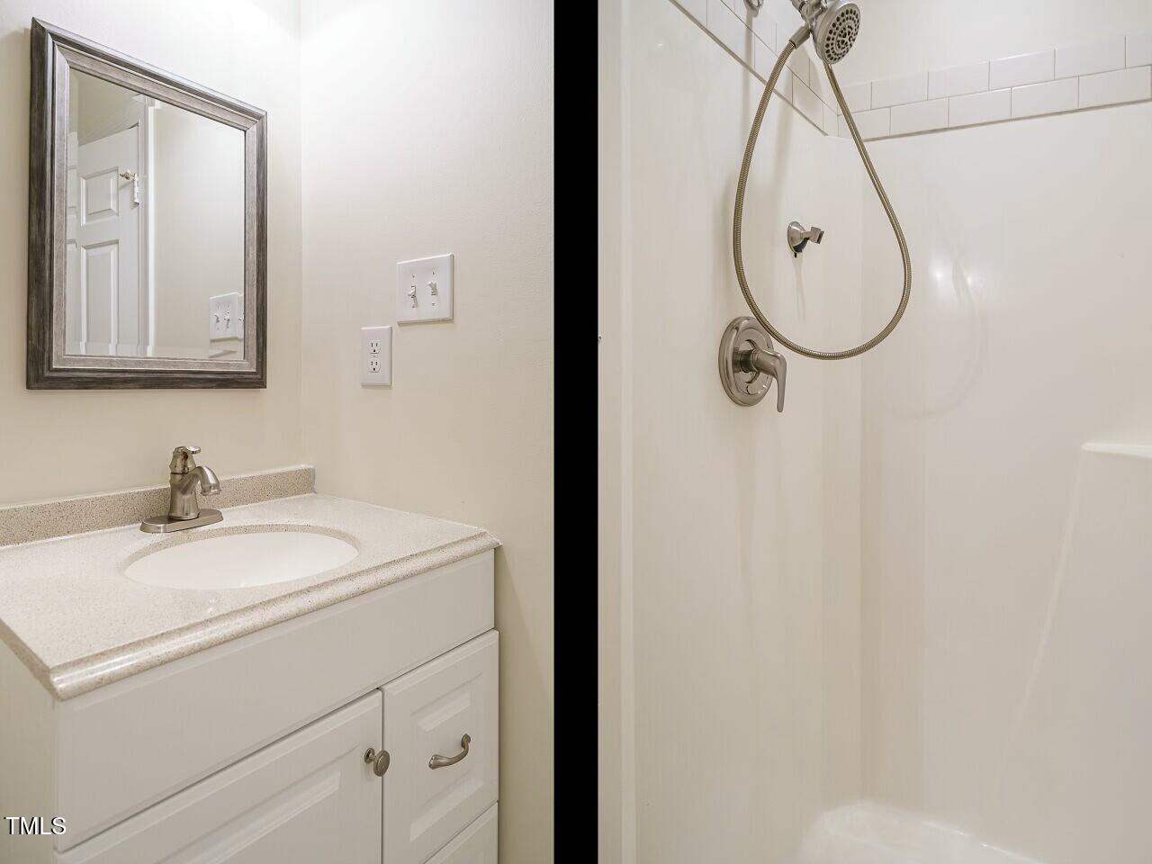 5917 Sentinel Drive Raleigh, NC 27609 - Photo 30 of 32 a bathroom with a sink and a mirror