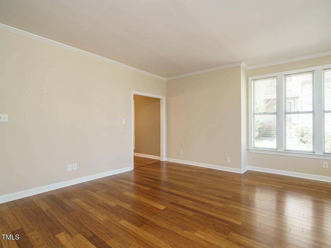 5917 Sentinel Drive Raleigh, NC 27609 - Photo 10 of 32 an empty room with wooden floor and windows