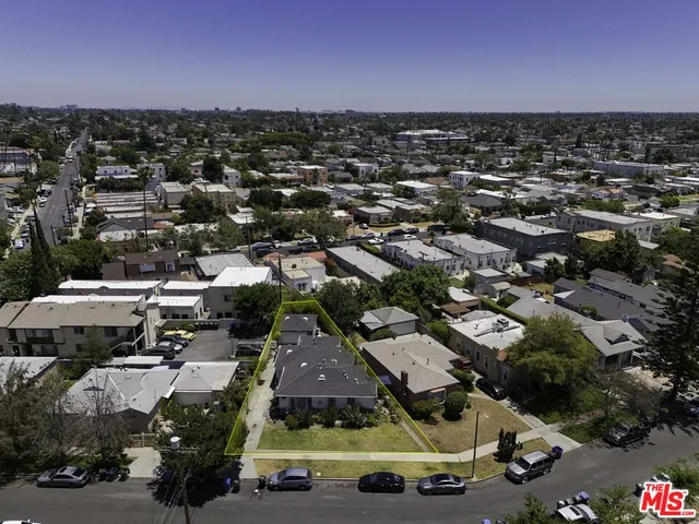 an aerial view of multiple houses with yard