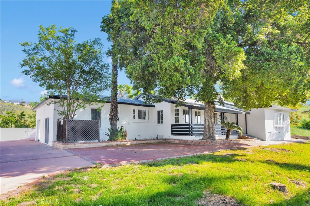 a backyard of a house with yard and outdoor seating