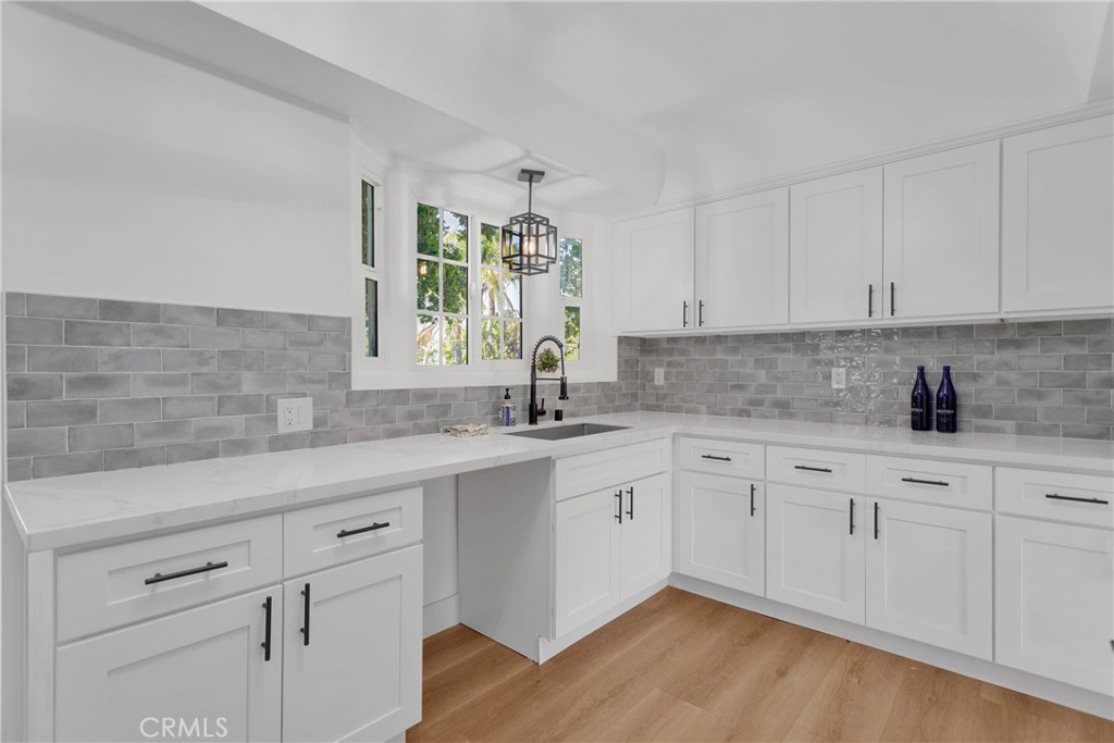 3489 Circle Road San Bernardino, CA 92405 - Photo 18 of 51 a kitchen with granite countertop white cabinets white appliances and sink