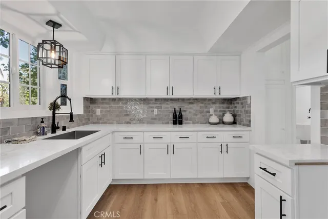 a kitchen with granite countertop white cabinets and white appliances