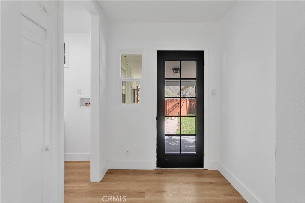 3489 Circle Road San Bernardino, CA 92405 - Photo 21 of 51 a view of an empty room with wooden floor and a window