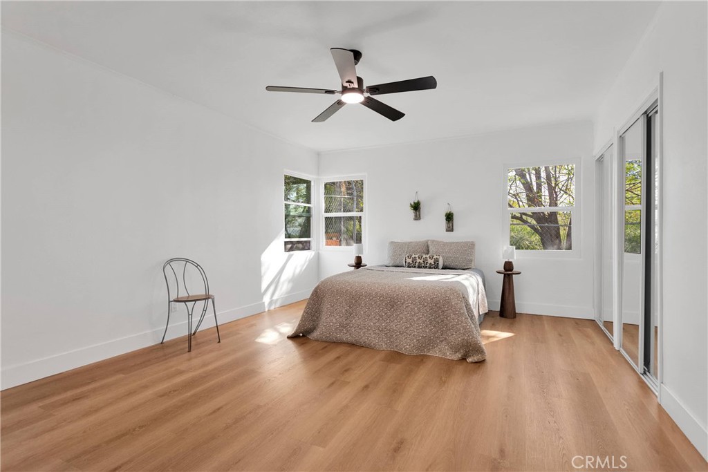 3489 Circle Road San Bernardino, CA 92405 - Photo 24 of 51 a bedroom with a bed large window with wooden floor