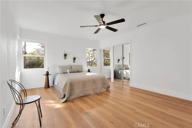 a bedroom with a bed and a chair