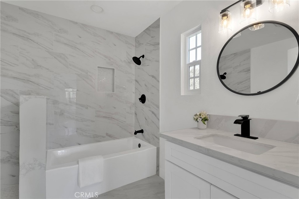 3489 Circle Road San Bernardino, CA 92405 - Photo 28 of 51 a bathroom with a sink a bathtub and a mirror