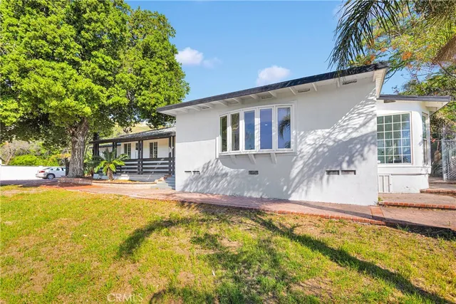 a swimming pool with outdoor seating and yard