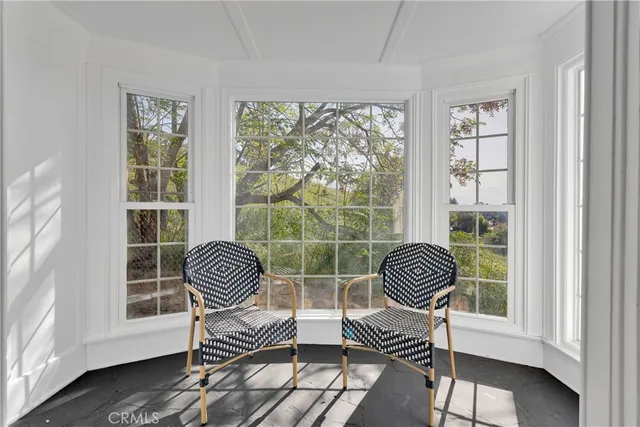 a chair sitting in a room next to a window