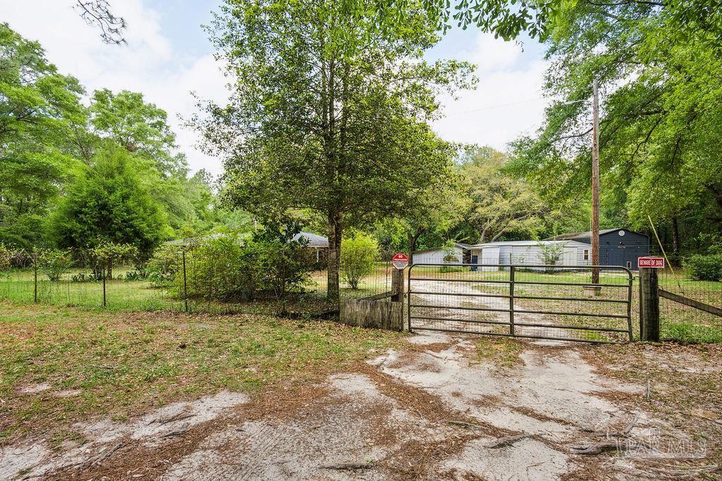 8938 Pioneer Road Holt, FL 32564 - Photo 43 of 44 a view of a yard with wooden fence