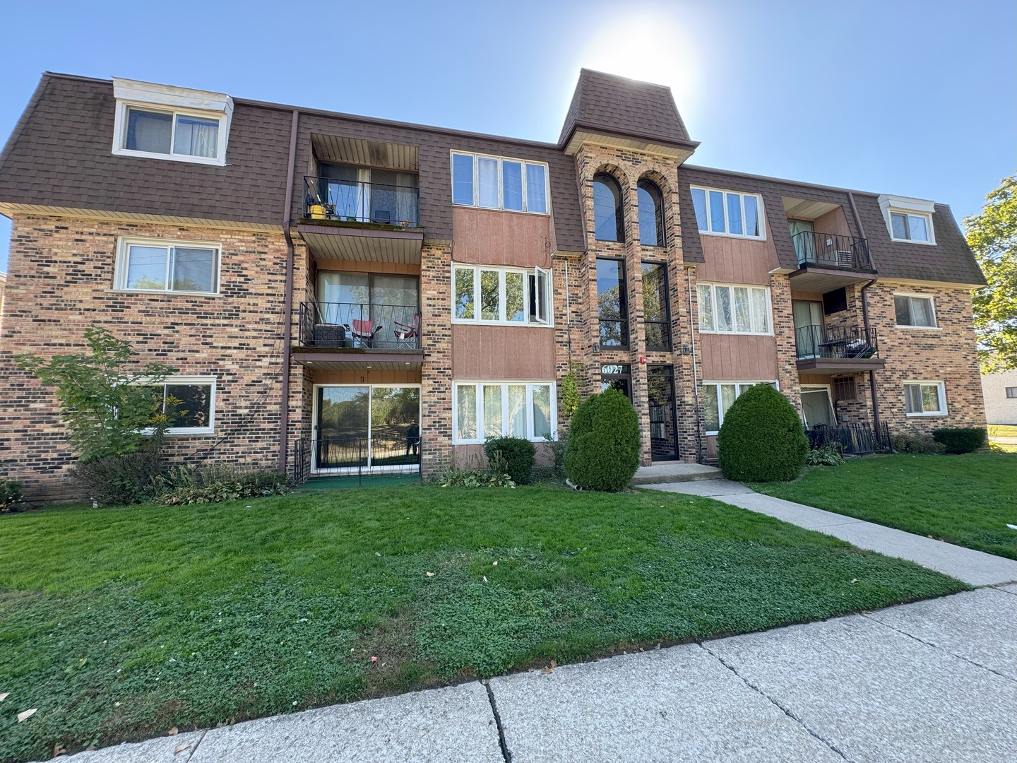 6027 103rd Street, Unit 1A Chicago Ridge, IL 60415 - Photo 21 of 22 a front view of a house with a yard