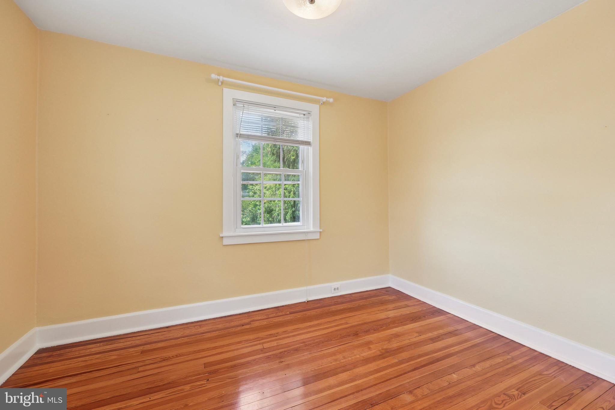 427 Righters Mill Road Gladwyne, PA 19035 - Photo 8 of 16 a view of an empty room with wooden floor and a window