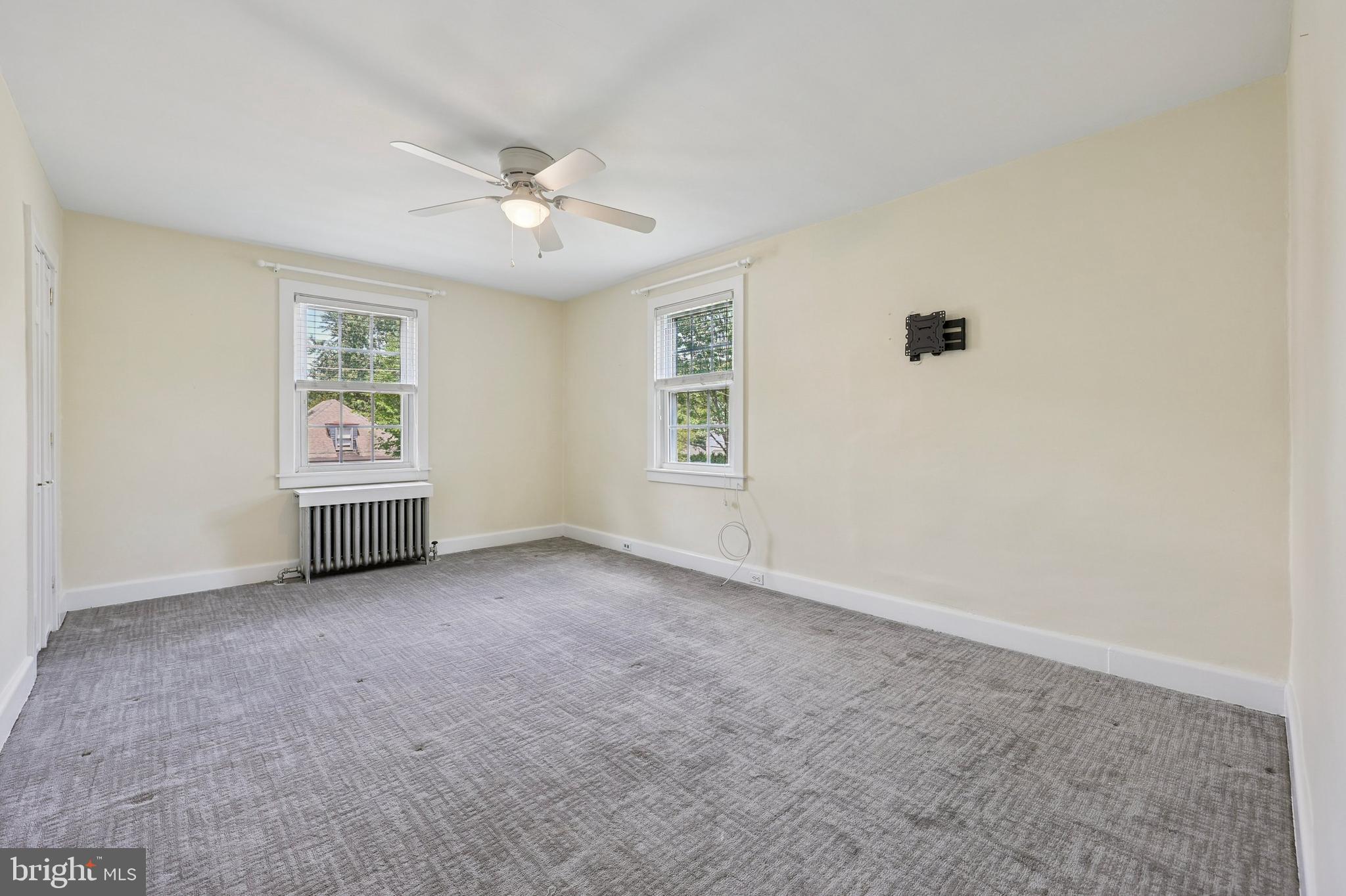 427 Righters Mill Road Gladwyne, PA 19035 - Photo 9 of 16 an empty room with windows and ceiling fan view