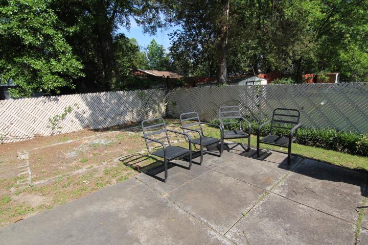 4177 Spirea Drive Columbus, GA 31907 - Photo 21 of 21 a view of backyard with a table and chairs under an umbrella