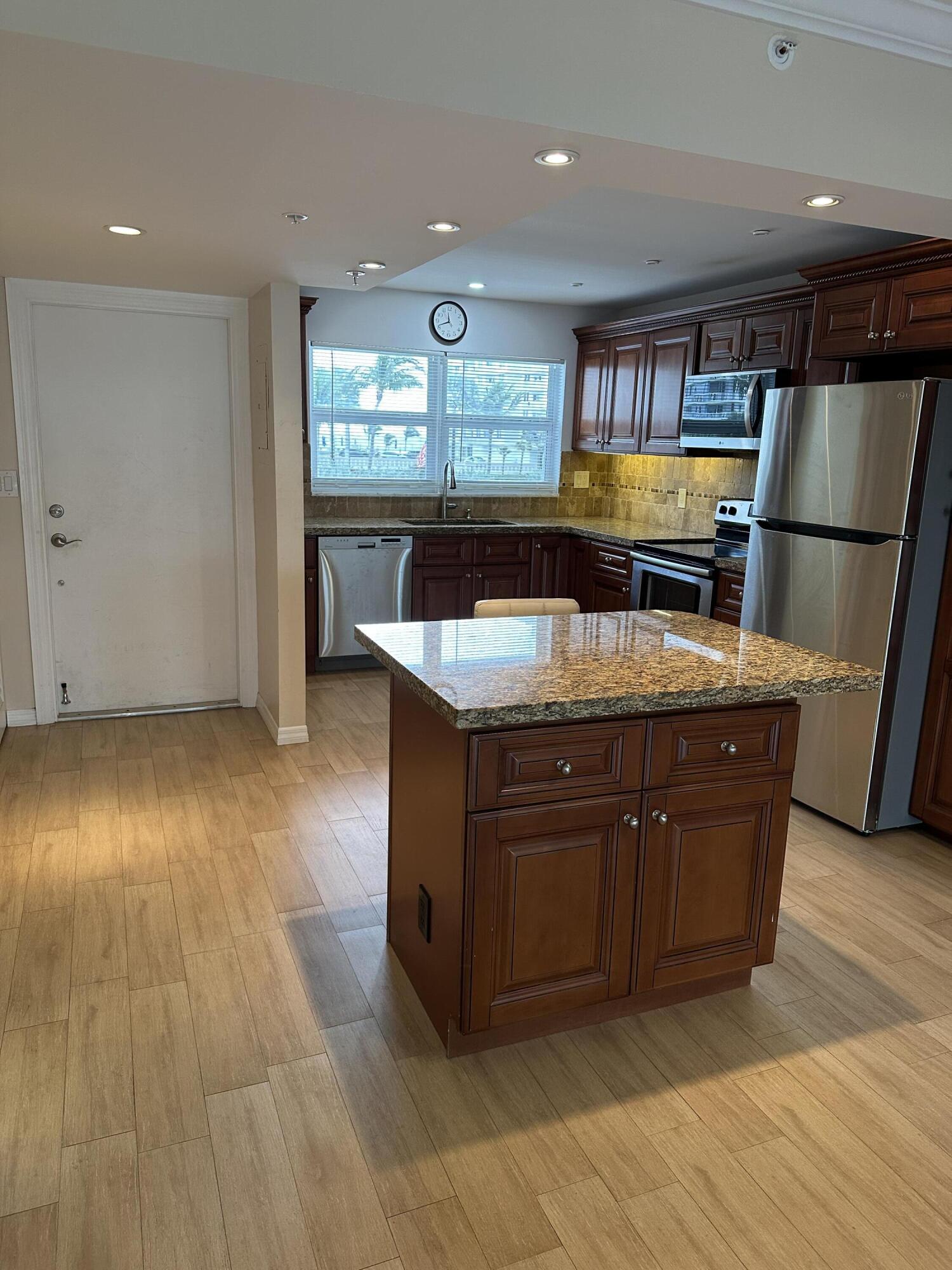3224 South Ocean Boulevard, Unit 310B Highland Beach, FL 33487 - Photo 2 of 26 a kitchen with stainless steel appliances granite countertop a sink and a stove