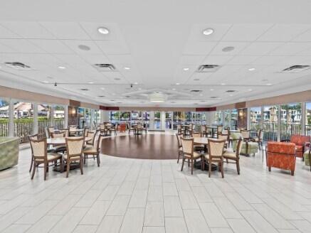 3224 South Ocean Boulevard, Unit 310B Highland Beach, FL 33487 - Photo 22 of 26 a dining room with lots of tables a large window and chairs