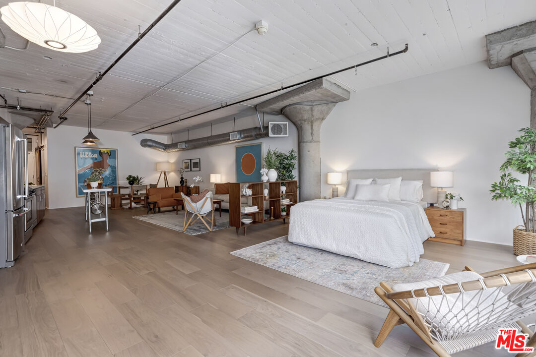 200 North San Fernando Road, Unit 208 Los Angeles, CA 90031 - Photo 16 of 37 a bedroom with furniture and a flat screen tv