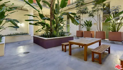 a swimming pool with outdoor seating and wooden floor