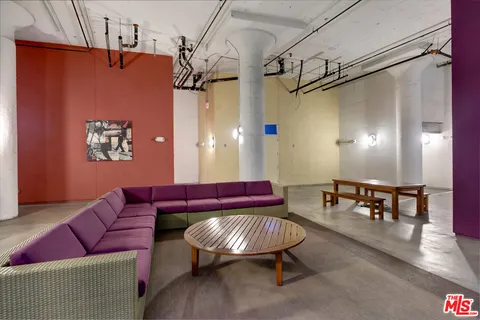 a living room with furniture and a dining table