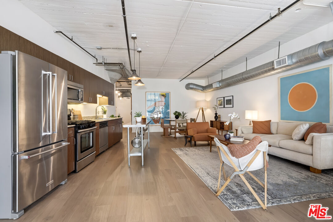 200 North San Fernando Road, Unit 208 Los Angeles, CA 90031 - Photo 4 of 37 a living room with lots of stainless steel appliances furniture and a kitchen view