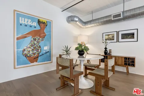 a dining room with furniture and wooden floor