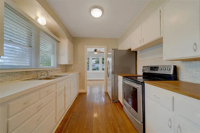 a stove top oven sitting inside of a kitchen
