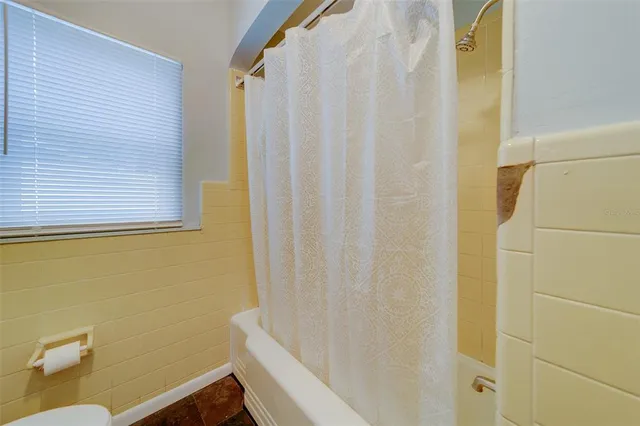 a view of a room with wooden floor and window
