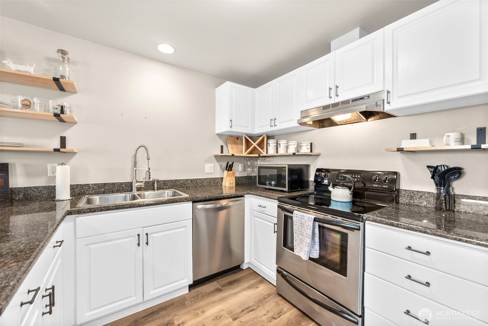218 Broadway, Unit 5 Tacoma, WA 98402 - Photo 11 of 32 a kitchen with stainless steel appliances granite countertop a sink a stove and cabinets