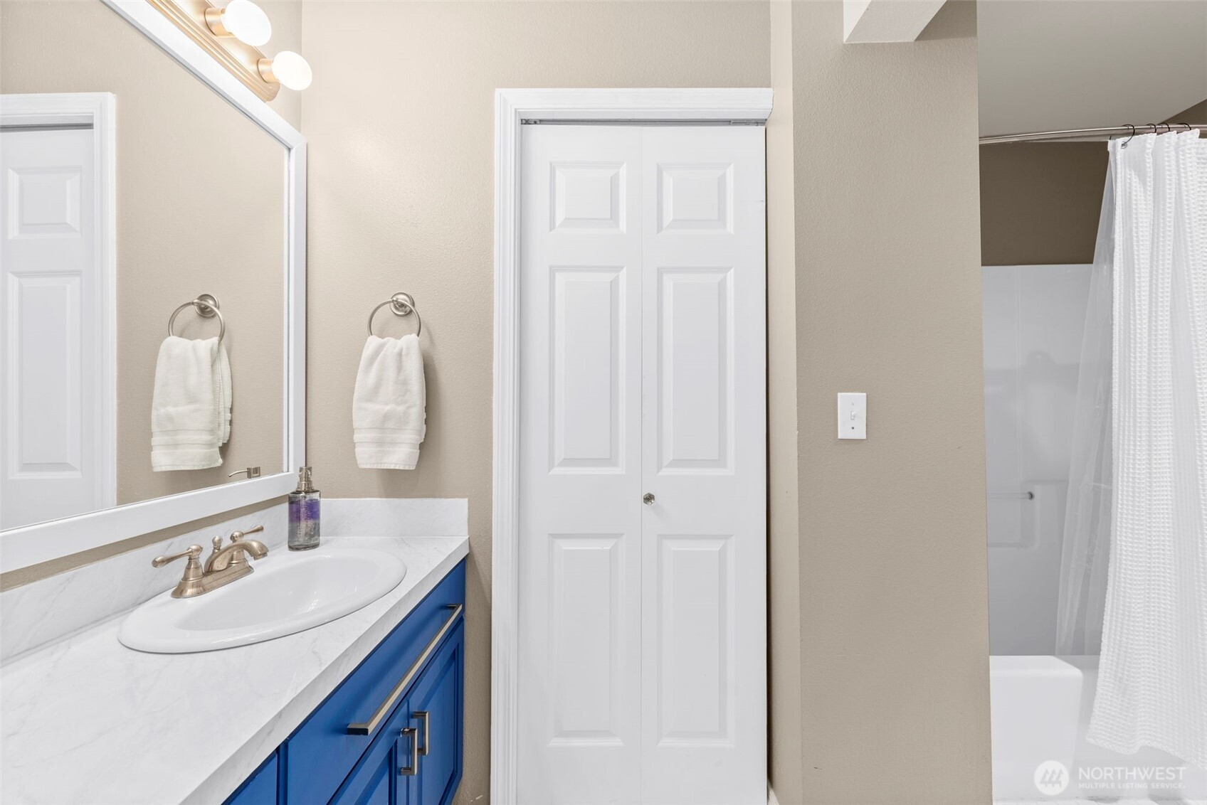 218 Broadway, Unit 5 Tacoma, WA 98402 - Photo 15 of 32 a bathroom with a double vanity sink and a mirror