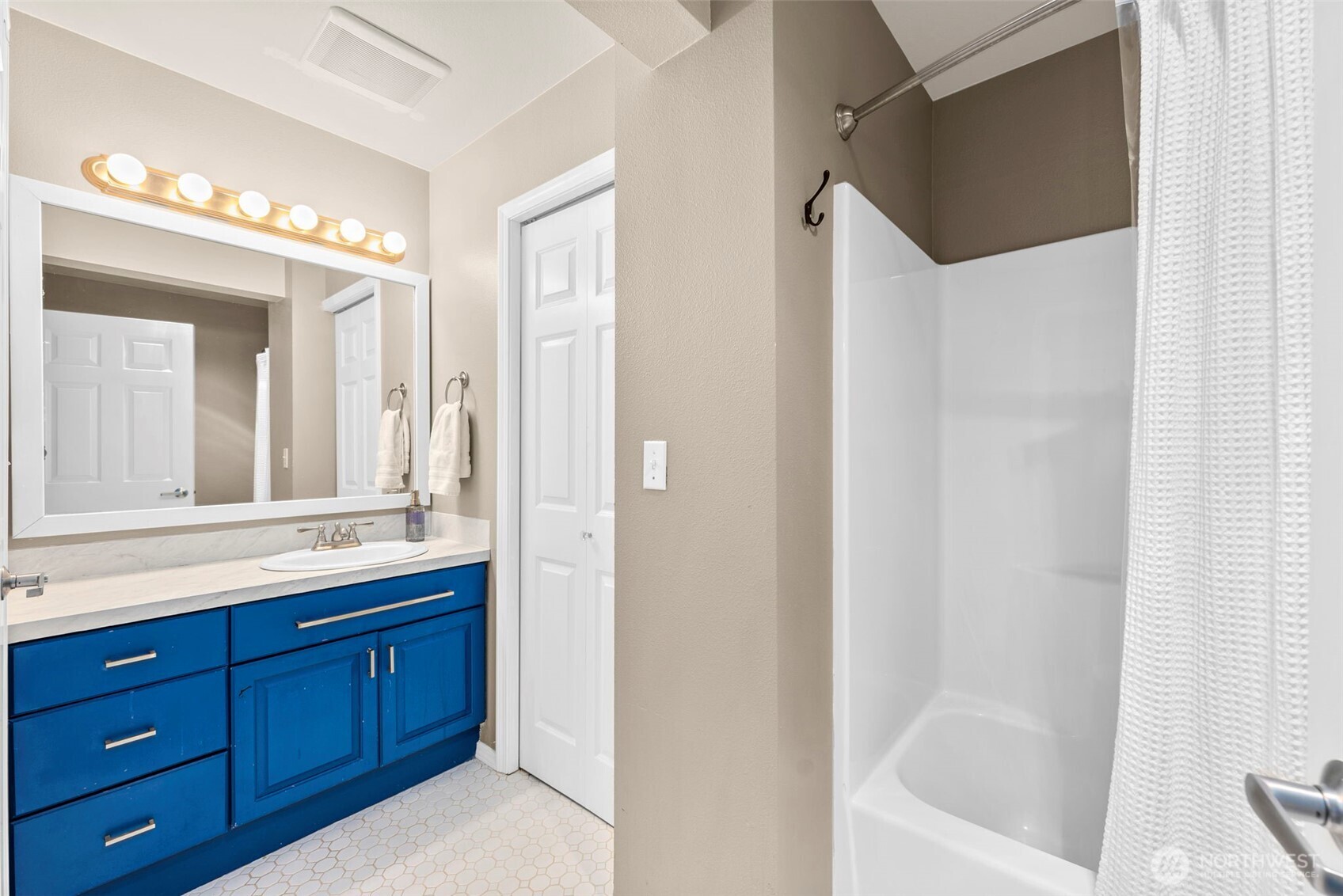 218 Broadway, Unit 5 Tacoma, WA 98402 - Photo 16 of 32 a bathroom with a tub a sink and mirrors