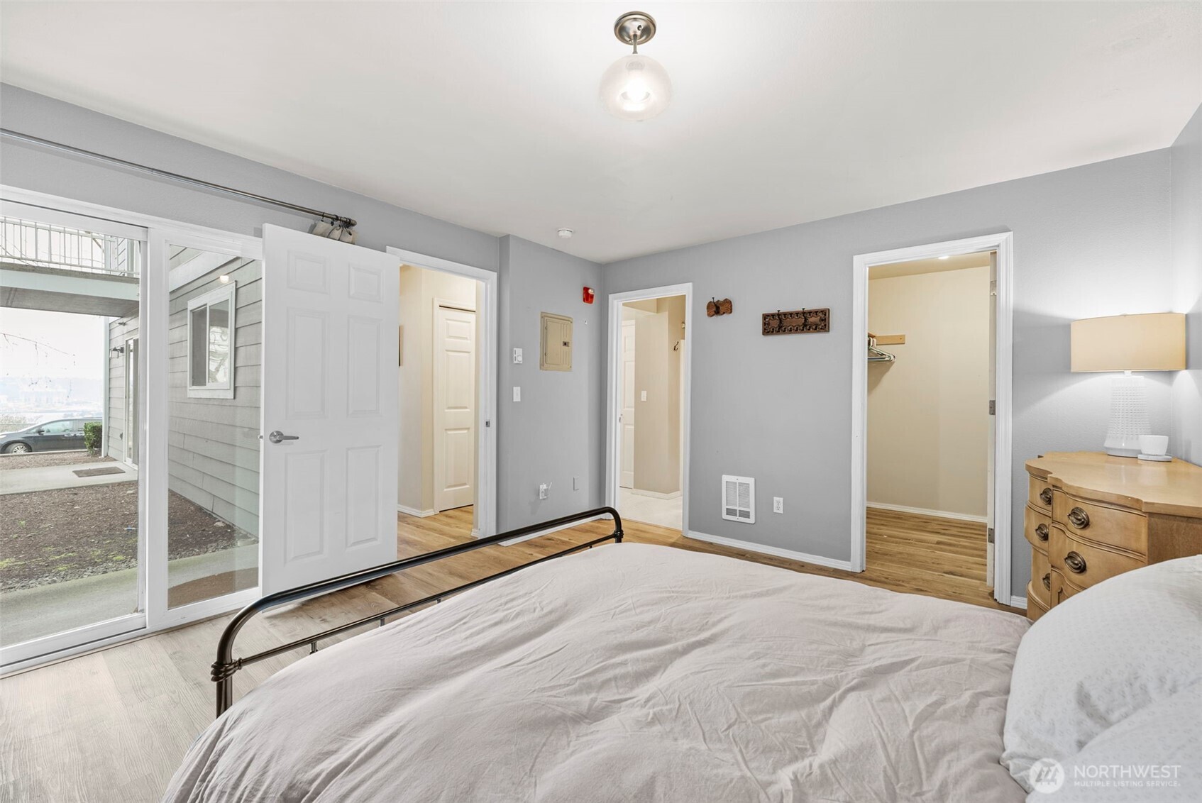 218 Broadway, Unit 5 Tacoma, WA 98402 - Photo 19 of 32 a view of a bedroom with a bed and wooden floor