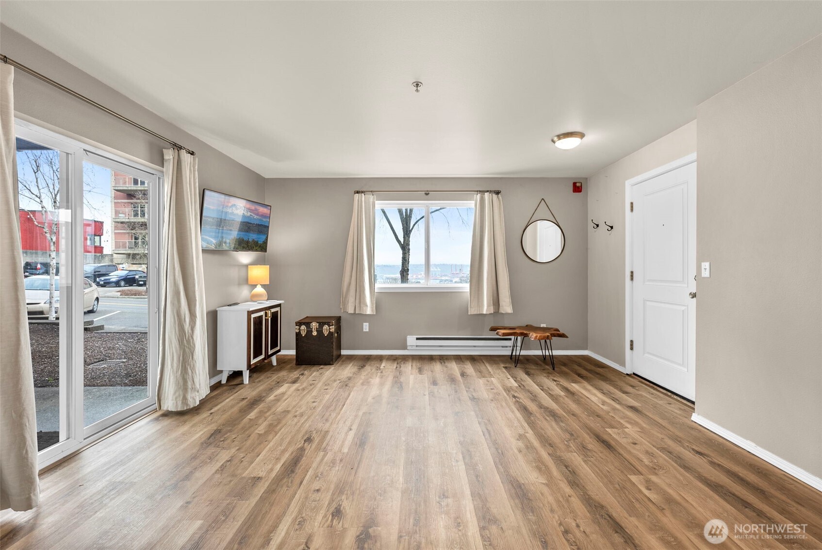 218 Broadway, Unit 5 Tacoma, WA 98402 - Photo 7 of 32 wooden floor in an empty room with a window