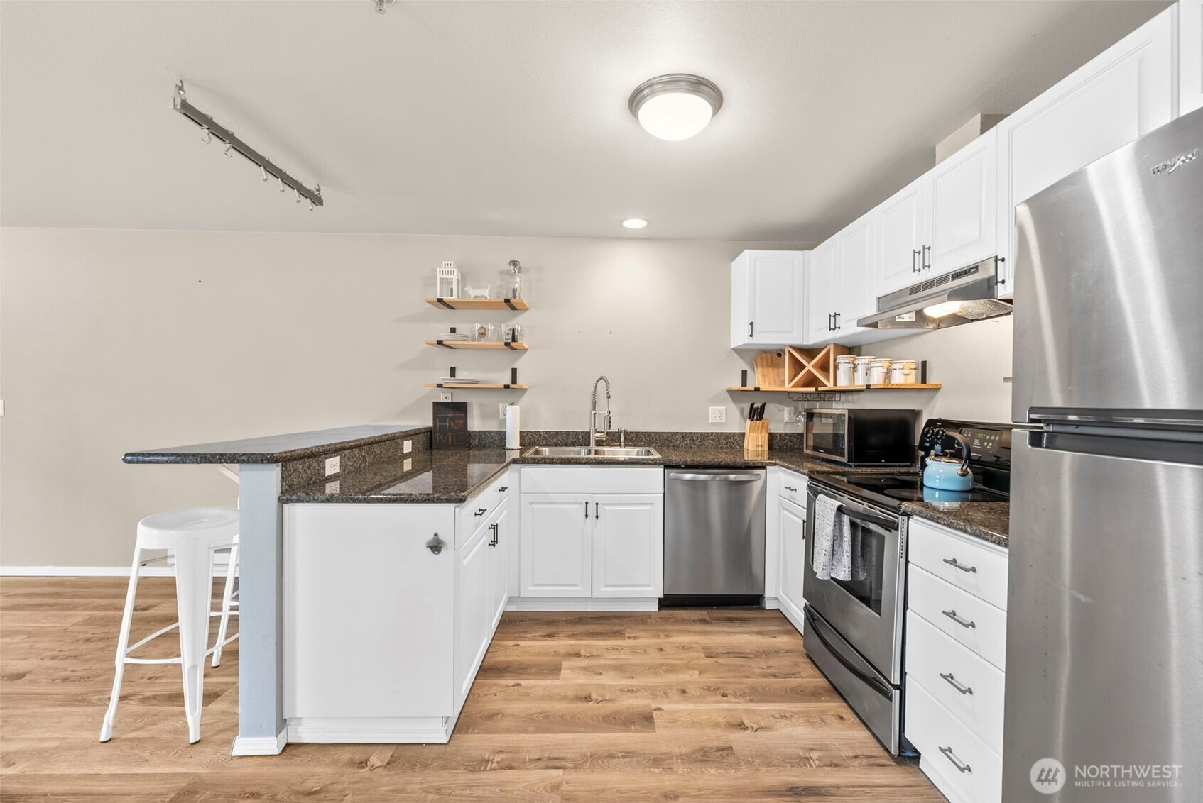 218 Broadway, Unit 5 Tacoma, WA 98402 - Photo 10 of 32 a kitchen with granite countertop a sink appliances and cabinets