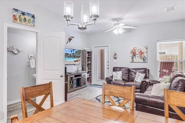a living room with furniture and a chandelier