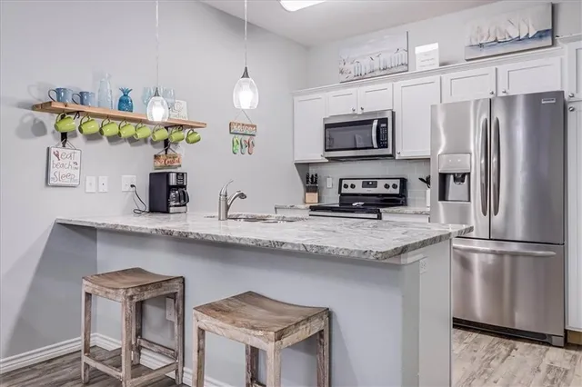 a living room with furniture kitchen view and a dining table