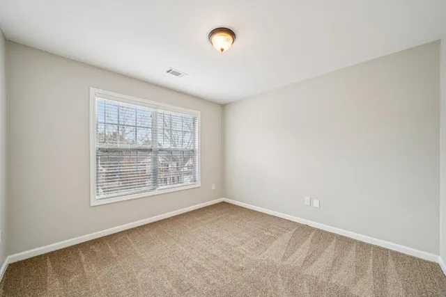 an empty room with a empty space and windows