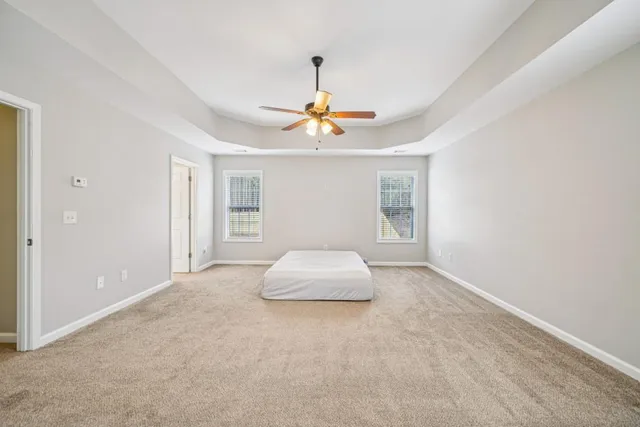 a bedroom with bed tv and window