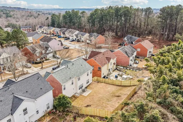 an aerial view of residential houses with outdoor space