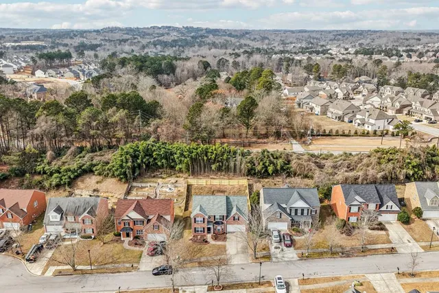an aerial view of a house with a yard