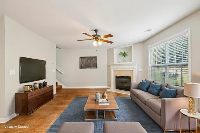 a living room with furniture a fireplace and a flat screen tv