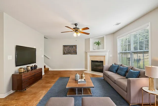 a living room with furniture a fireplace and a flat screen tv