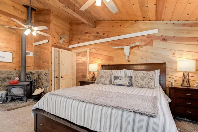 a large bed sitting in a bedroom next to a window