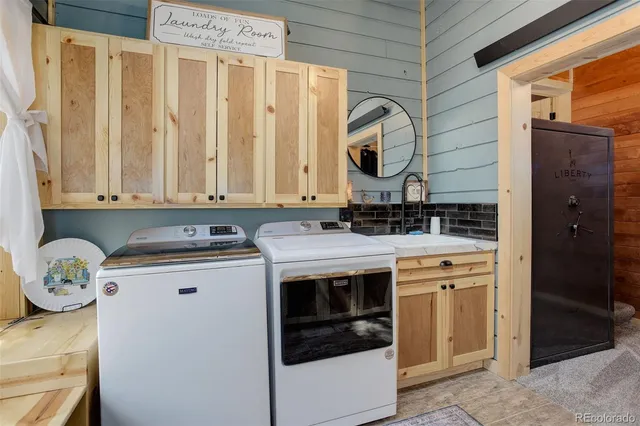 a view of cabinets a washer and dryer
