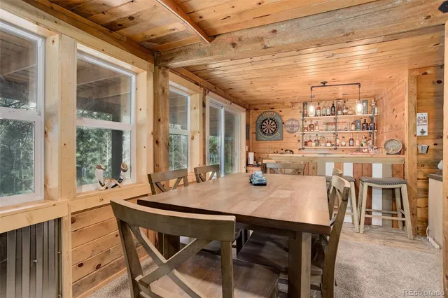 a view of a dining room with furniture large windows and wooden floor