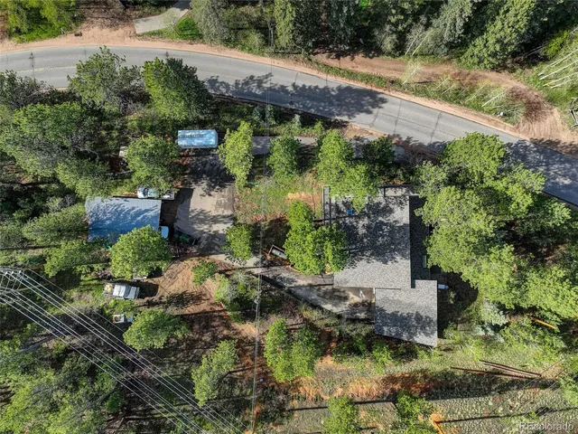 an aerial view of a house with a yard
