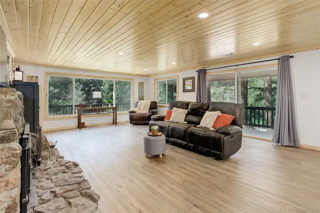 a living room with furniture and a floor to ceiling window